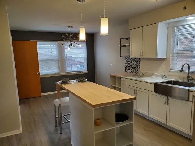 a kitchen with stainless steel appliances a stove a sink and a refrigerator