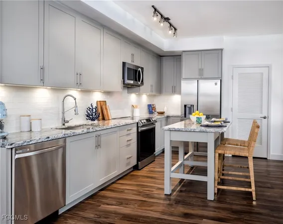 a kitchen with a sink cabinets and wooden floor
