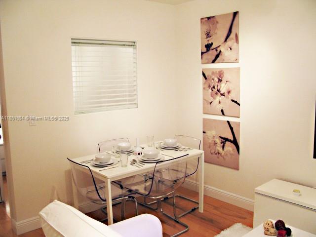 921 Meridian Avenue, Unit 9 Miami Beach, FL 33139 - Photo 4 of 17 a dining room with furniture and a window