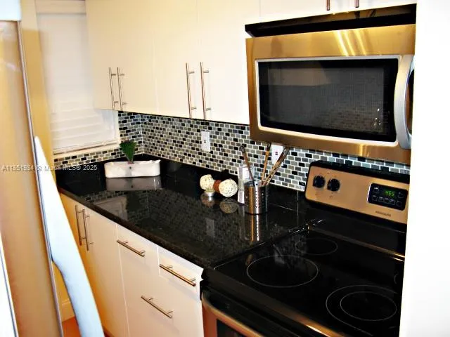 a kitchen with a stove and a microwave