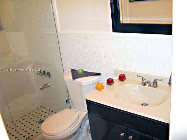 921 Meridian Avenue, Unit 9 Miami Beach, FL 33139 - Photo 10 of 17 a bathroom with a sink a toilet and shower curtain
