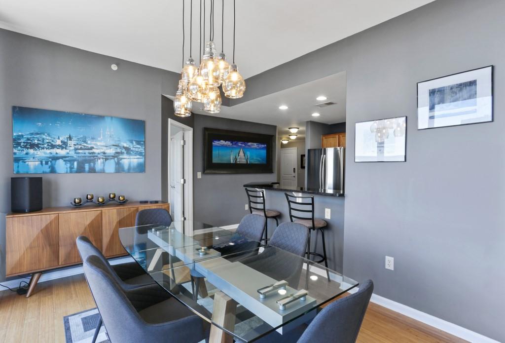 3040 Peachtree Road Northwest, Unit 1003 Atlanta, GA 30305 - Photo 1 of 1 a living room with furniture and a chandelier