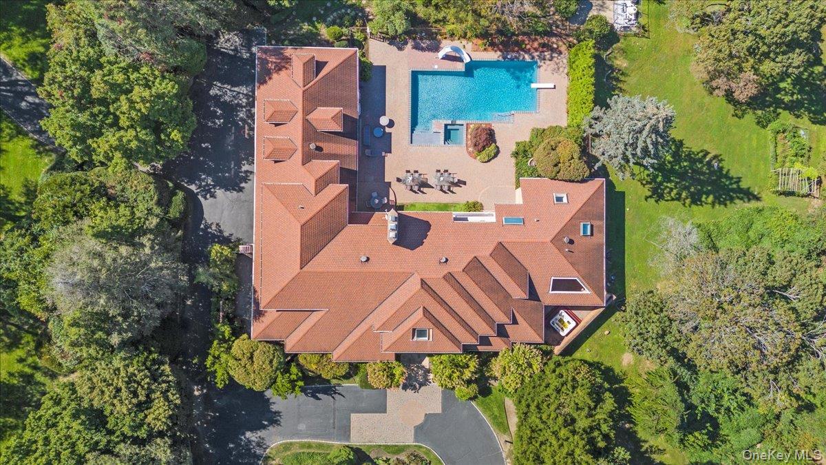 12 Ridge Court Glen Head, NY 11545 - Photo 46 of 46 Drone / aerial view of a pool area and a tree filled landscape