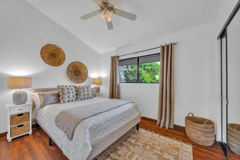 a bedroom with bed and wooden floor