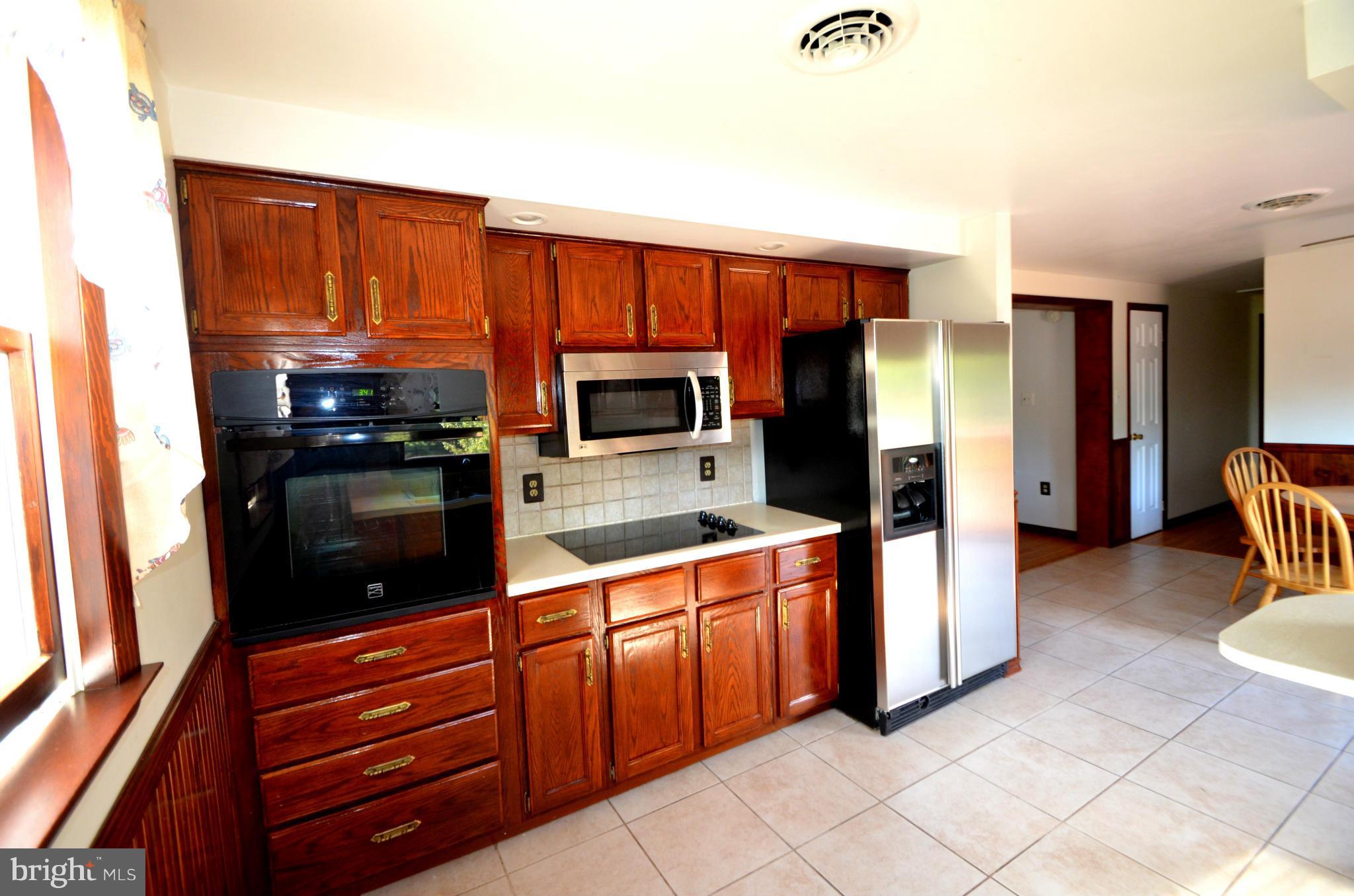 1403 Pleasant View Road Tuscarora, MD 21790 - Photo 5 of 13 a kitchen with stainless steel appliances granite countertop a refrigerator and a stove top oven