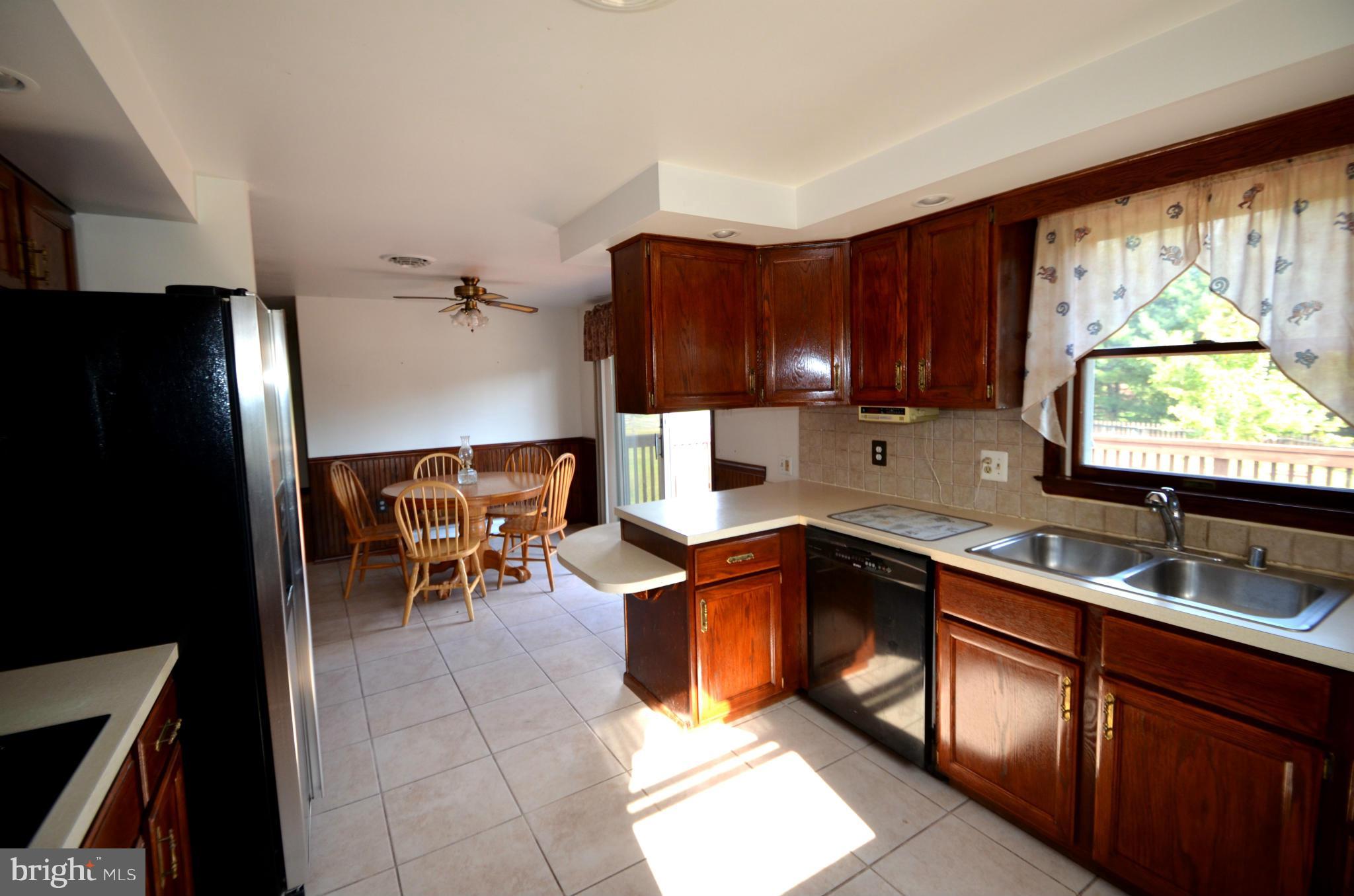 1403 Pleasant View Road Tuscarora, MD 21790 - Photo 6 of 13 a kitchen with stainless steel appliances granite countertop sink refrigerator and window