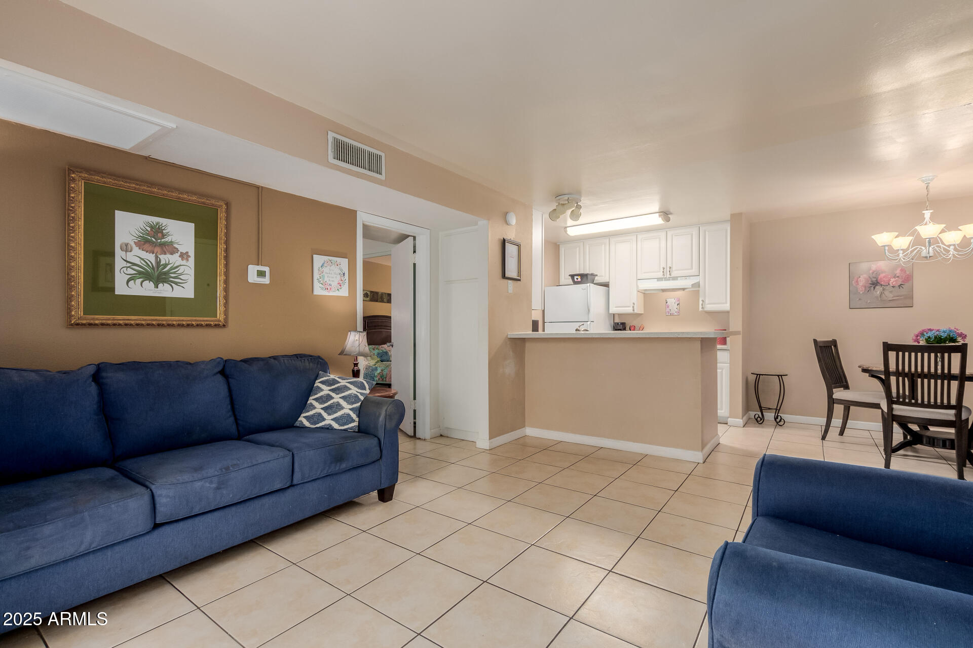 8055 East Thomas Road, Unit C104 Scottsdale, AZ 85251 - Photo 3 of 24 a living room with furniture and kitchen view