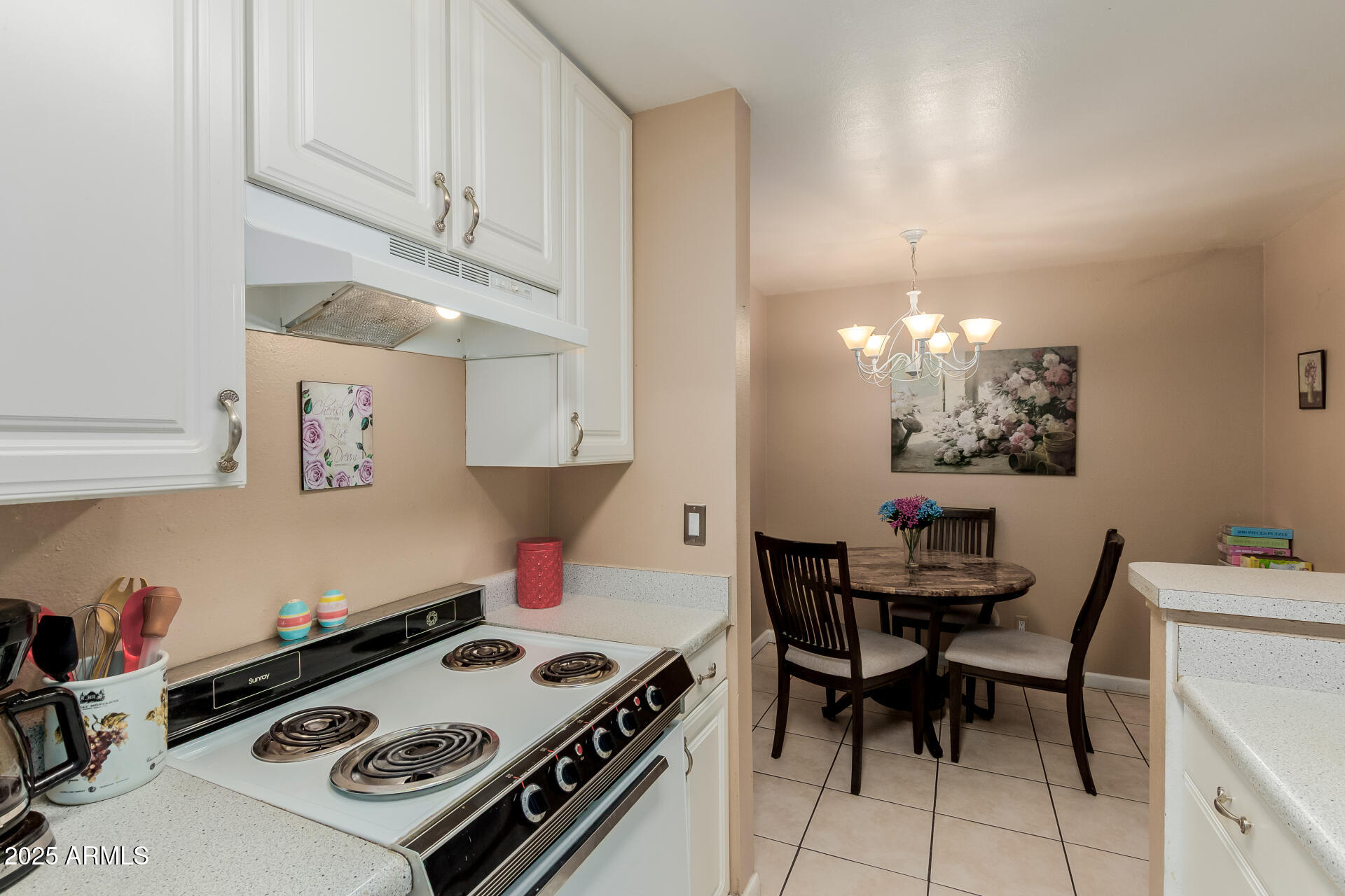 8055 East Thomas Road, Unit C104 Scottsdale, AZ 85251 - Photo 6 of 24 a kitchen with a stove a table and chairs in it