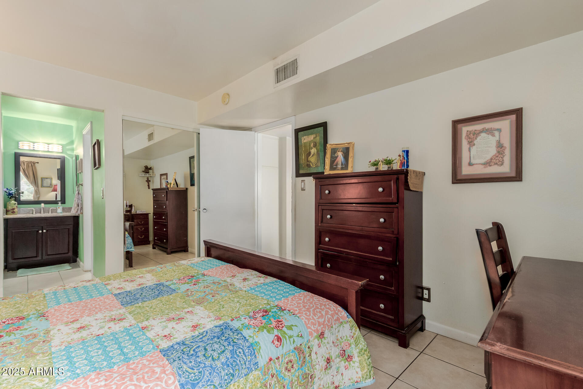 8055 East Thomas Road, Unit C104 Scottsdale, AZ 85251 - Photo 8 of 24 a bedroom with a bed and a chair in it