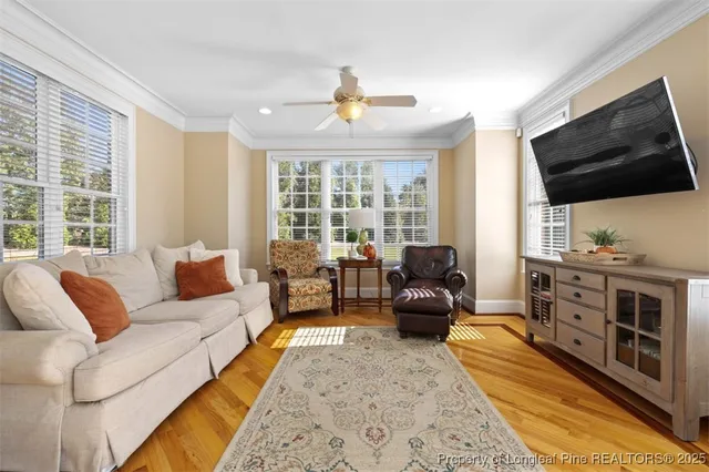 a living room with furniture fireplace and flat screen tv