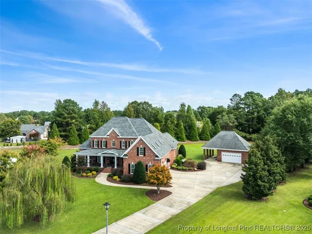 an aerial view of a house with big yard