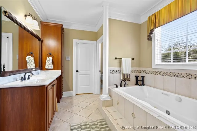 a bathroom with a tub a sink and a large mirror
