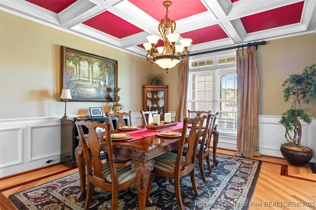 a view of a dining room with furniture and chandelier