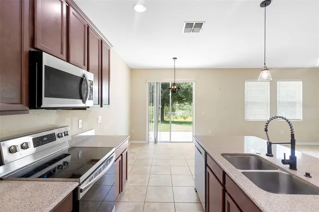 a kitchen with a sink and a stove top oven