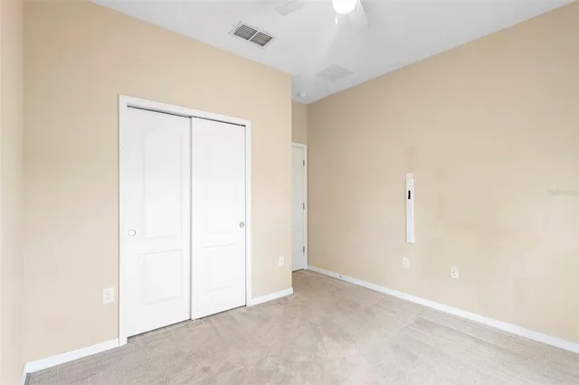 an empty room with closet area