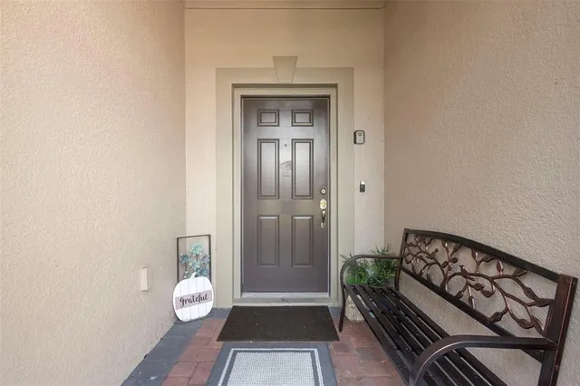 a view of a hallway with wooden floor and a bedroom