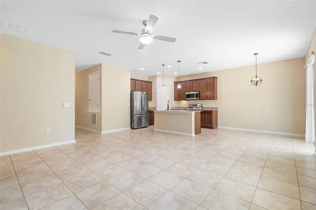 a view of a kitchen with a sink and stainless steel appliances