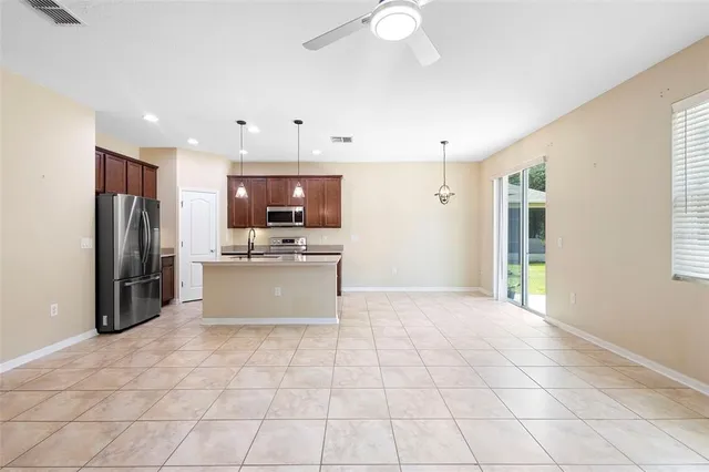a large kitchen with cabinets and stainless steel appliances