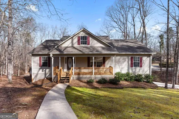a front view of a house with garden and porch