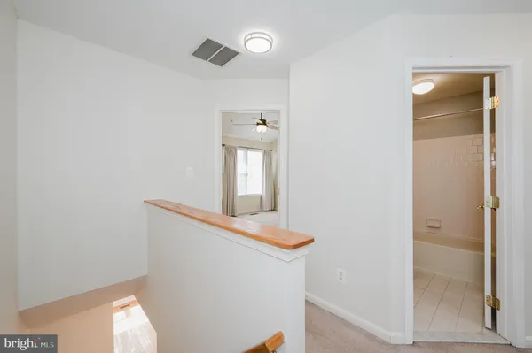 a spacious bathroom with a toilet sink and mirror