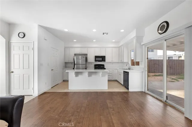 a view of kitchen with stainless steel appliances refrigerator oven and microwave