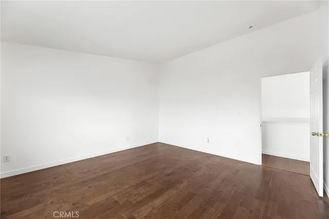 an empty room with wooden floor