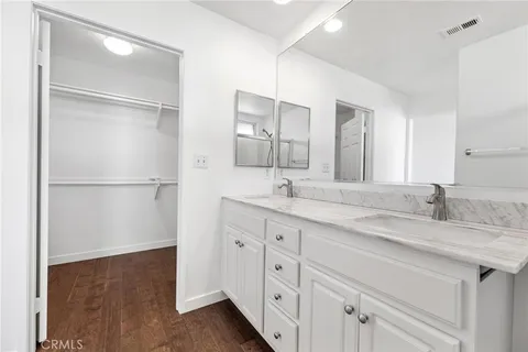 a bathroom with a double vanity sink and a mirror