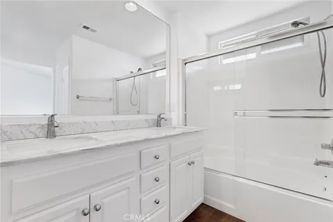 a bathroom with a granite countertop sink mirror and double