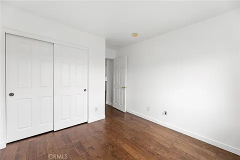a view of an empty room and wooden floor