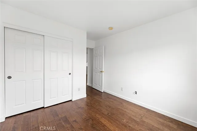 a view of an empty room and wooden floor