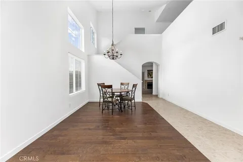 a view of a dining room with furniture and chandelier