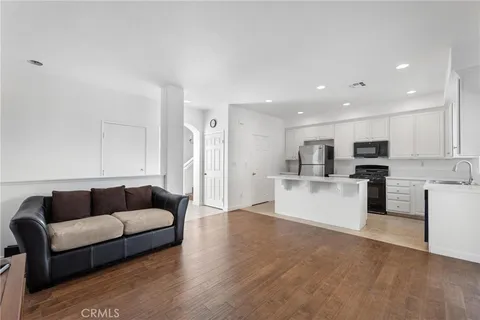 a living room with furniture and kitchen view