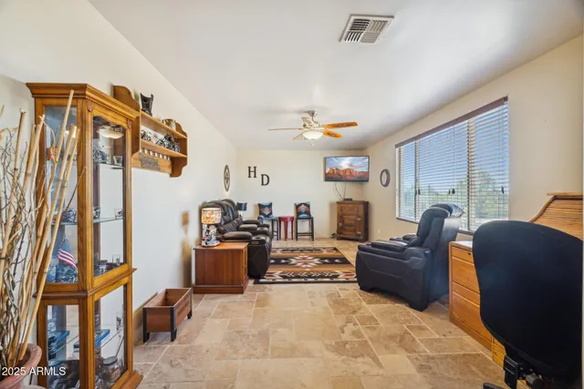 a kitchen with stainless steel appliances granite countertop a stove a refrigerator a kitchen island a table and chairs with wooden floor