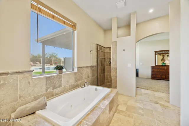 a bathroom with a granite countertop sink a toilet a mirror and shower