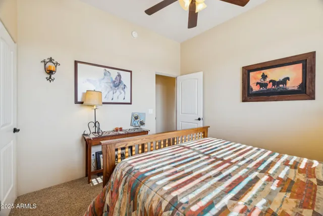 a bedroom with a bed and a dresser next to a window