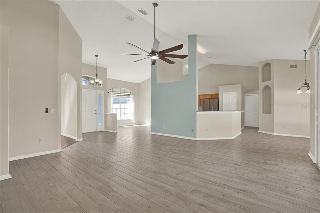 4400 Dior Road Spring Hill, FL 34609 - Photo 12 of 37 a view of a livingroom with a ceiling fan wooden floor and a ceiling fan