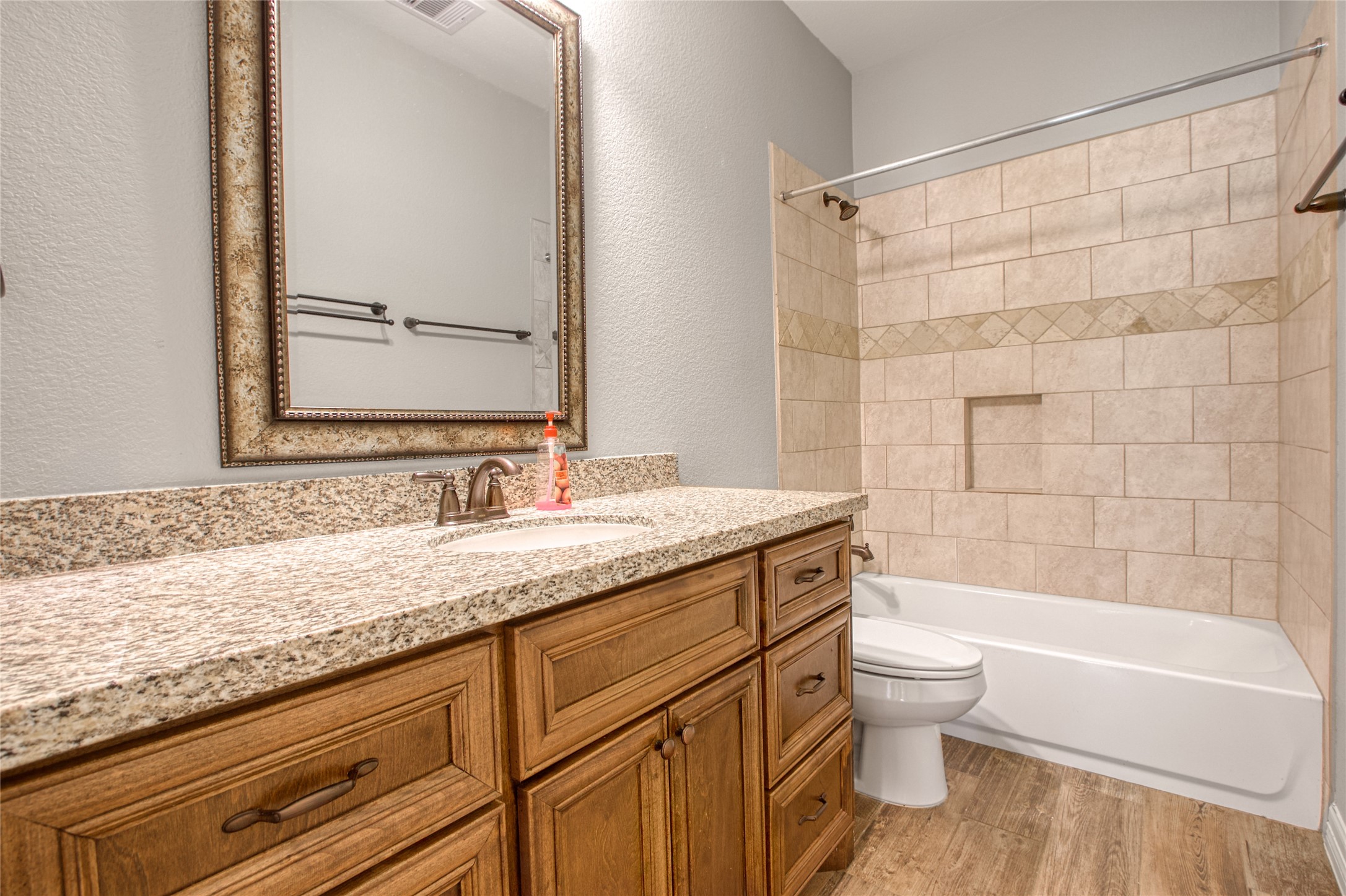 27684 Rio Blanco Drive Splendora, TX 77372 - Photo 22 of 31 a bathroom with a granite countertop sink a toilet and bathtub