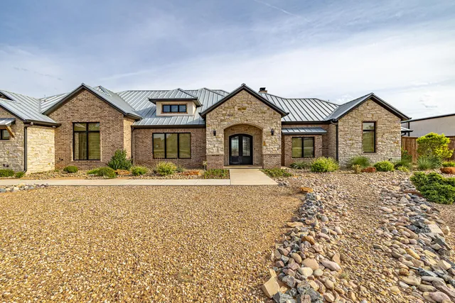 a kitchen with stainless steel appliances kitchen island granite countertop a stove a sink a refrigerator and a oven