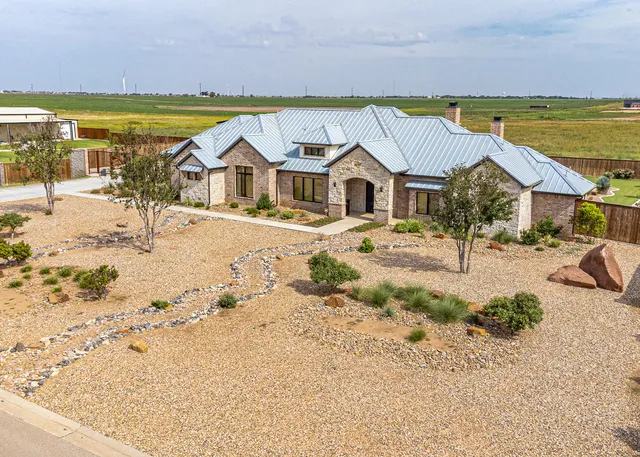 an aerial view of a house with a swimming pool