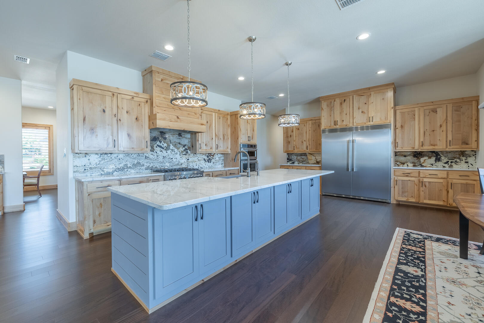 9018 County Road 6850 Lubbock, TX 79407 - Photo 46 of 103 a kitchen with stainless steel appliances kitchen island granite countertop a stove a sink a refrigerator and a oven