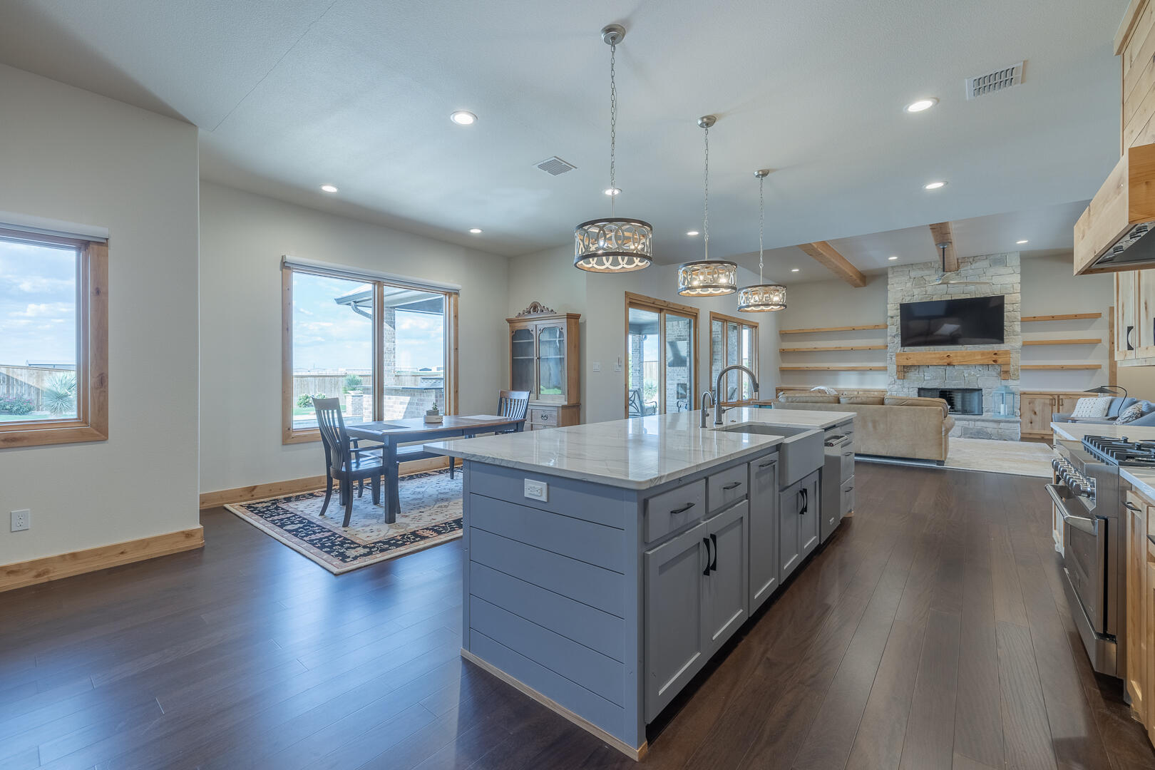 9018 County Road 6850 Lubbock, TX 79407 - Photo 53 of 103 a large kitchen with stainless steel appliances granite countertop a lot of counter space and wooden floor