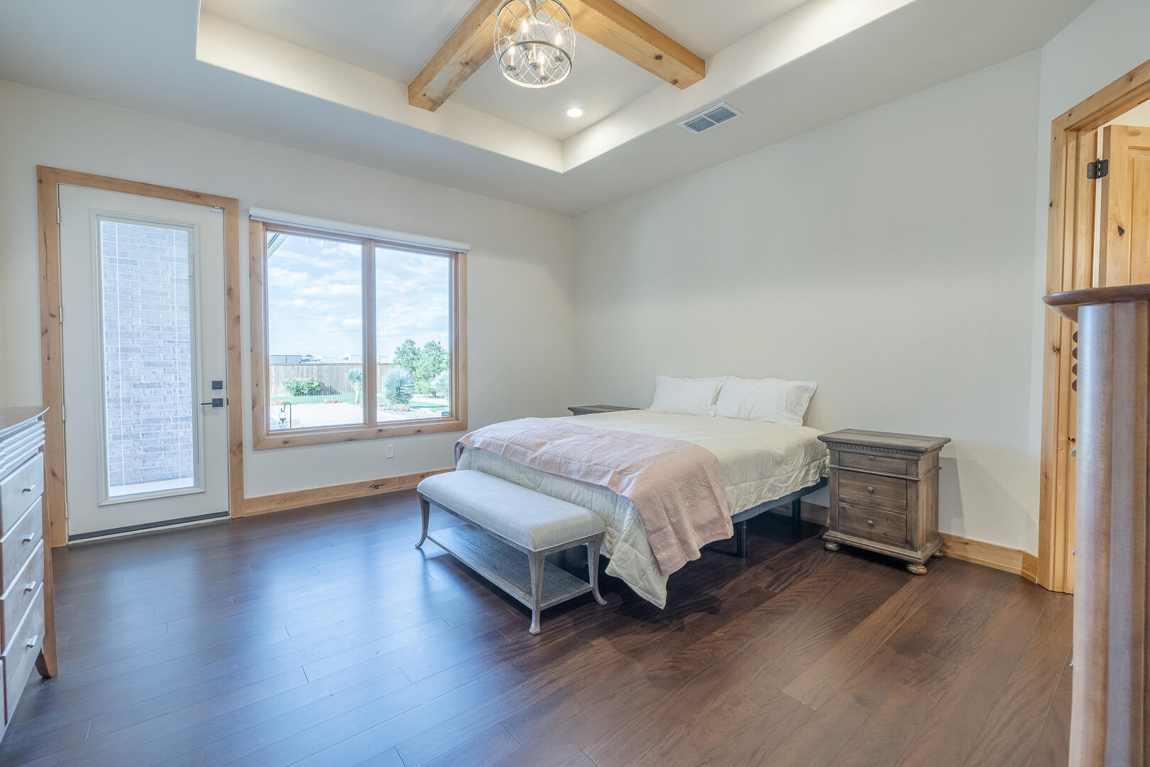 9018 County Road 6850 Lubbock, TX 79407 - Photo 61 of 103 a spacious bedroom with a bed and wooden floor