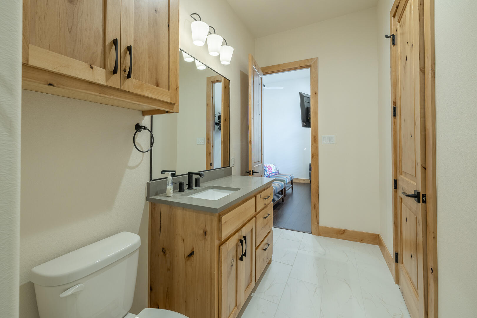 9018 County Road 6850 Lubbock, TX 79407 - Photo 74 of 103 a bathroom with a granite countertop sink a toilet and a mirror