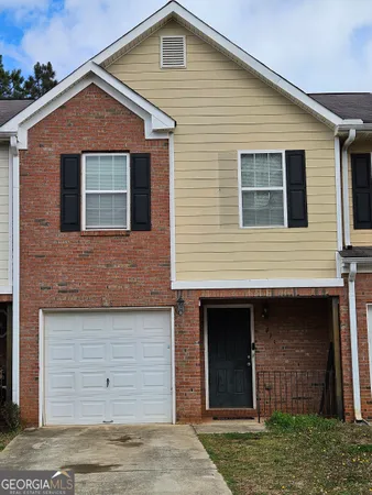 a front view of a house with a garage