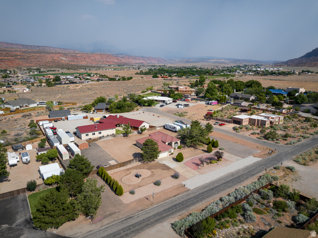 4297 Beeman Road Moab, UT 84532 - Photo 47 of 59 Expansive property featuring multiple structures, paved driveways, and surrounding natural landscaping