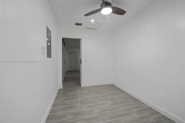 a view of an empty room with wooden floor