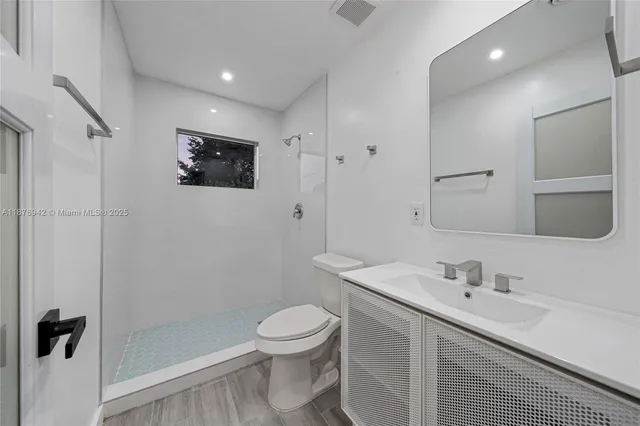 a view of a hallway with wooden floor and closet