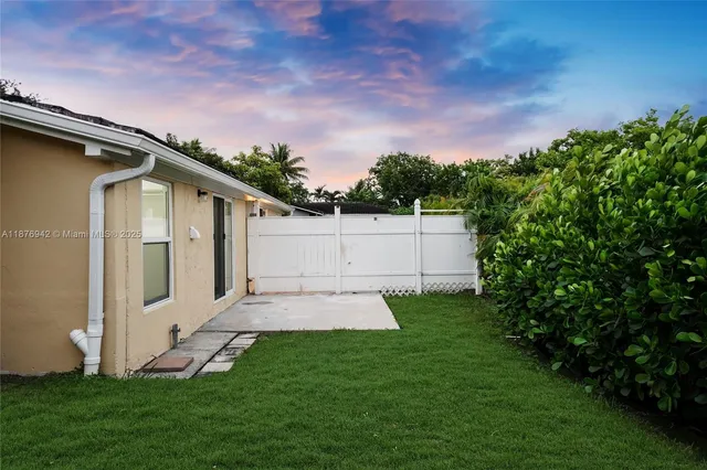 a front view of a house with a yard and fountain