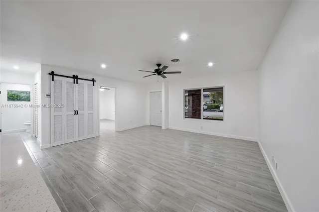 a view of an empty room with a window