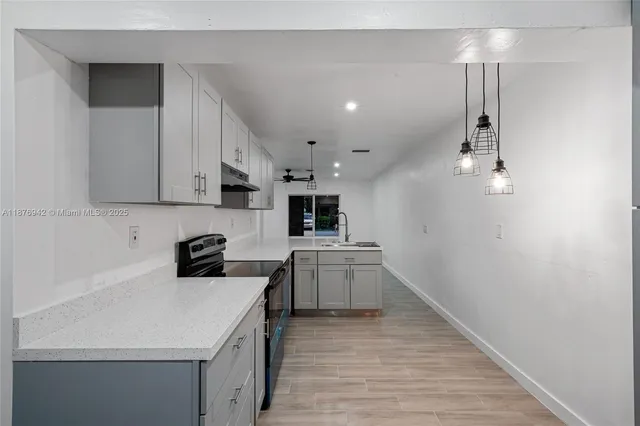 a kitchen with a sink a stove a microwave and cabinets